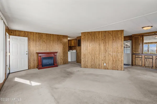 an empty room with furniture and a fireplace