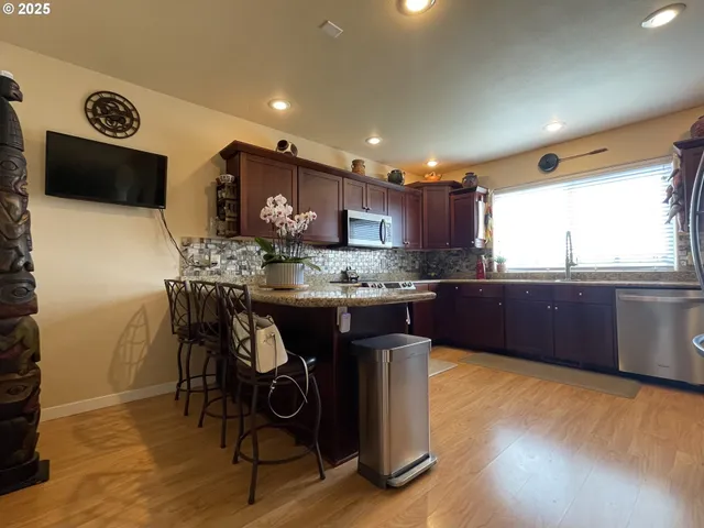 a kitchen with stainless steel appliances granite countertop a sink counter space and cabinets