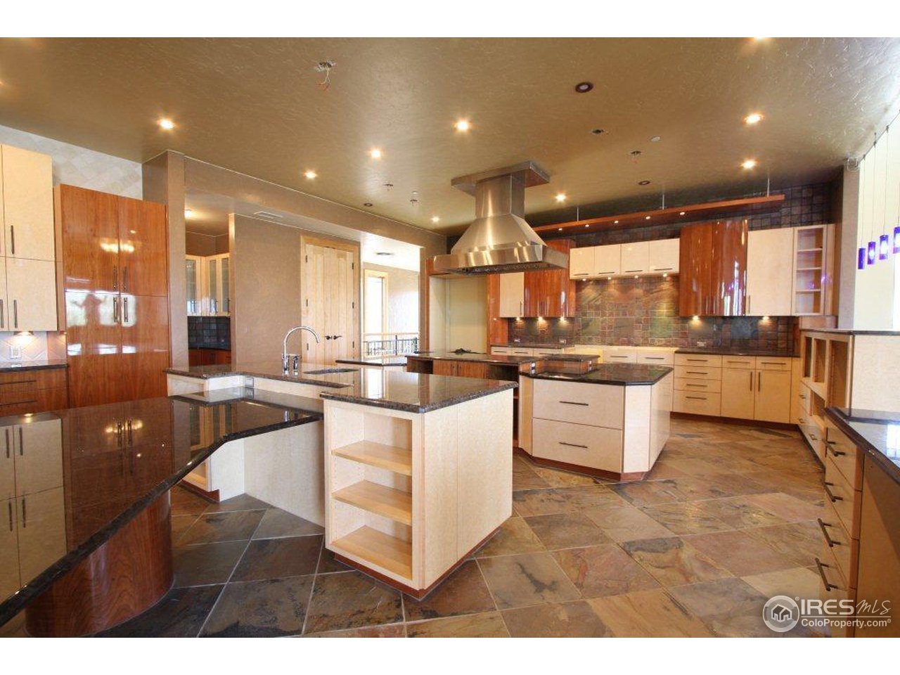 5385 Lookout Ridge Drive Boulder, CO 80301 - Photo 7 of 24 a kitchen with stainless steel appliances kitchen island granite countertop a sink and cabinets