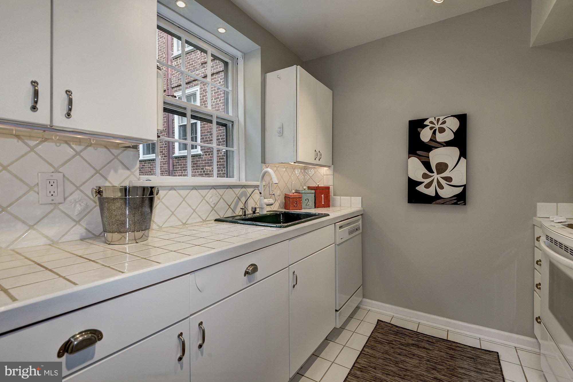 3500 39th Street Northwest, Unit B668 Washington, DC 20016 - Photo 11 of 29 a kitchen with sink cabinets and window