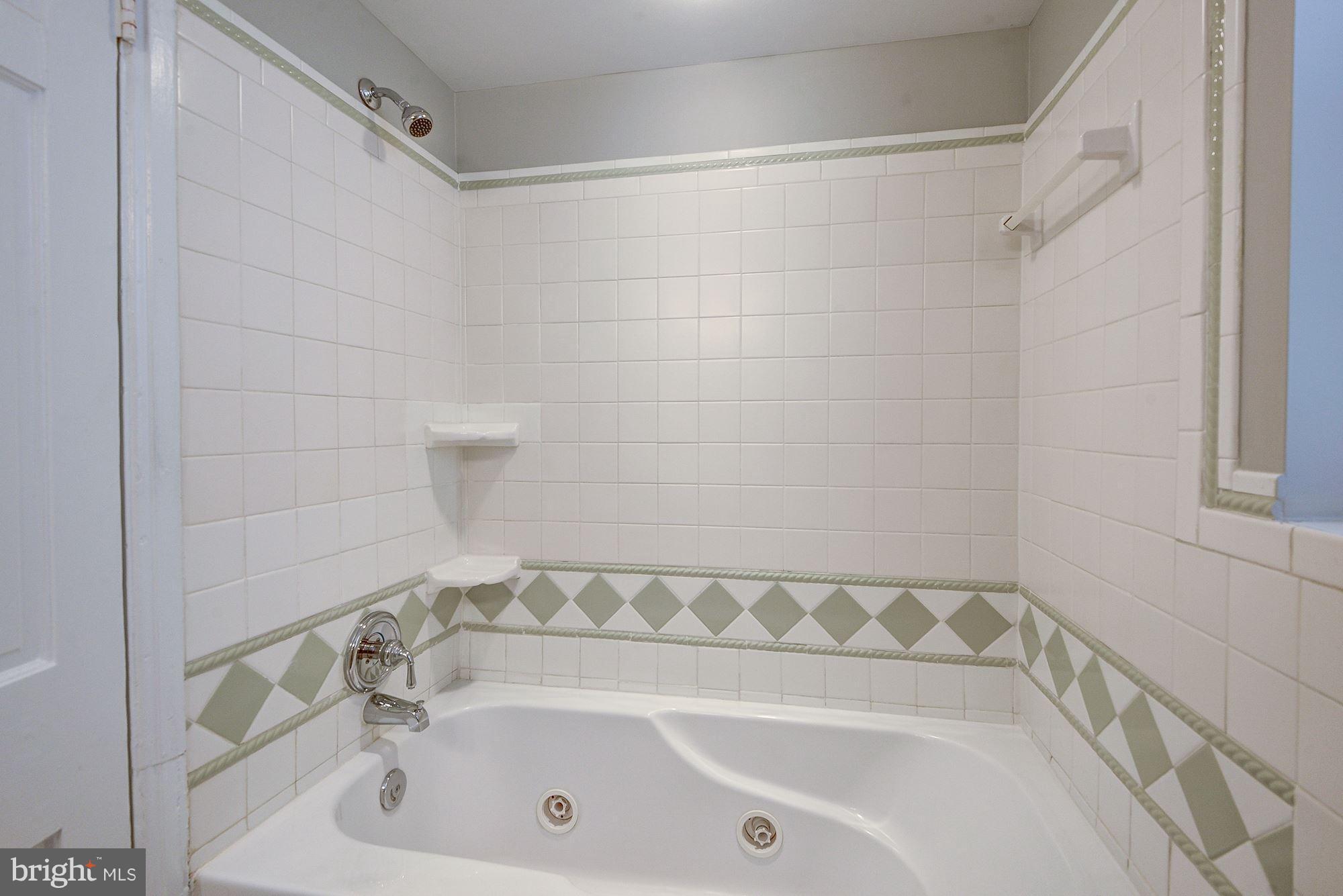 3500 39th Street Northwest, Unit B668 Washington, DC 20016 - Photo 18 of 29 a bathroom with a bathtub and a shower