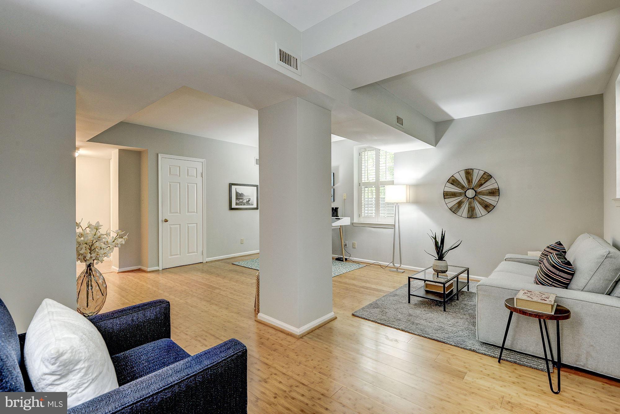 3500 39th Street Northwest, Unit B668 Washington, DC 20016 - Photo 19 of 29 a living room with furniture and a wooden floor