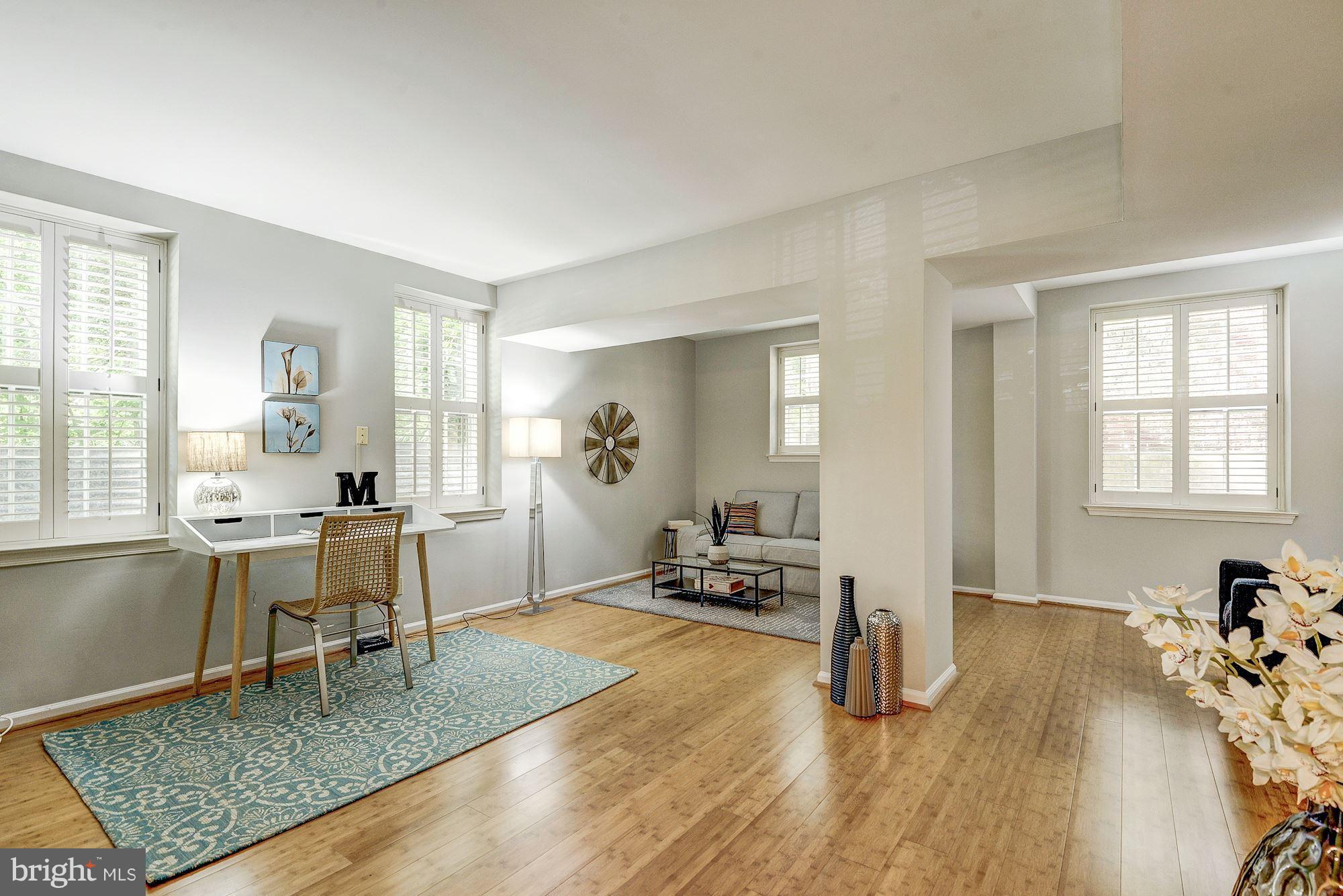 3500 39th Street Northwest, Unit B668 Washington, DC 20016 - Photo 22 of 29 a living room with furniture and a wooden floor