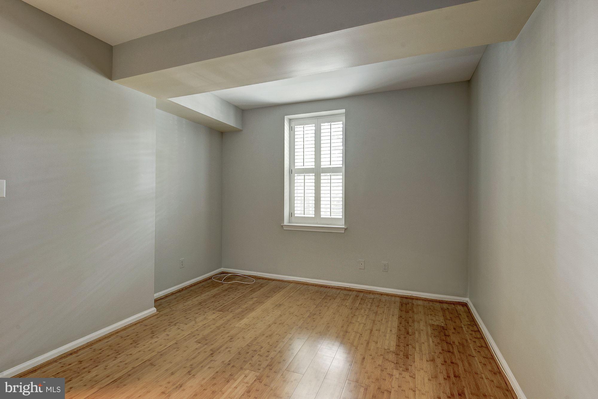 3500 39th Street Northwest, Unit B668 Washington, DC 20016 - Photo 26 of 29 an empty room with wooden floor and windows