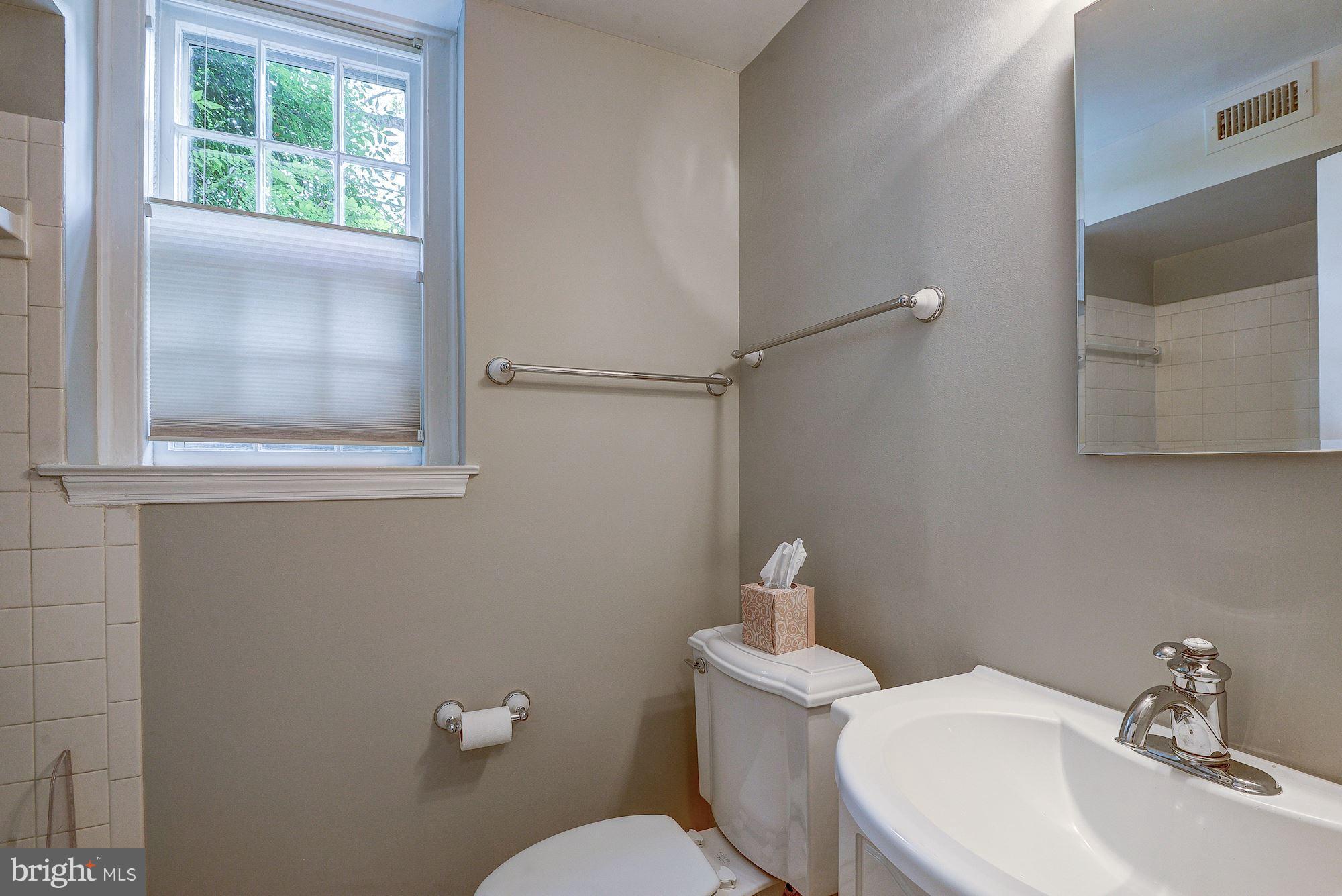 3500 39th Street Northwest, Unit B668 Washington, DC 20016 - Photo 29 of 29 a bathroom with a toilet a sink and mirror