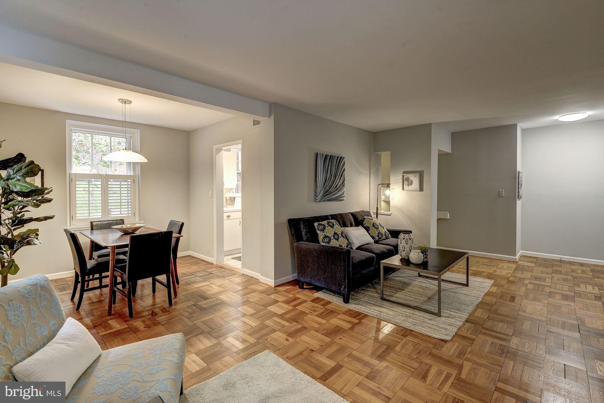 3500 39th Street Northwest, Unit B668 Washington, DC 20016 - Photo 5 of 29 a living room with furniture a dining table and a window