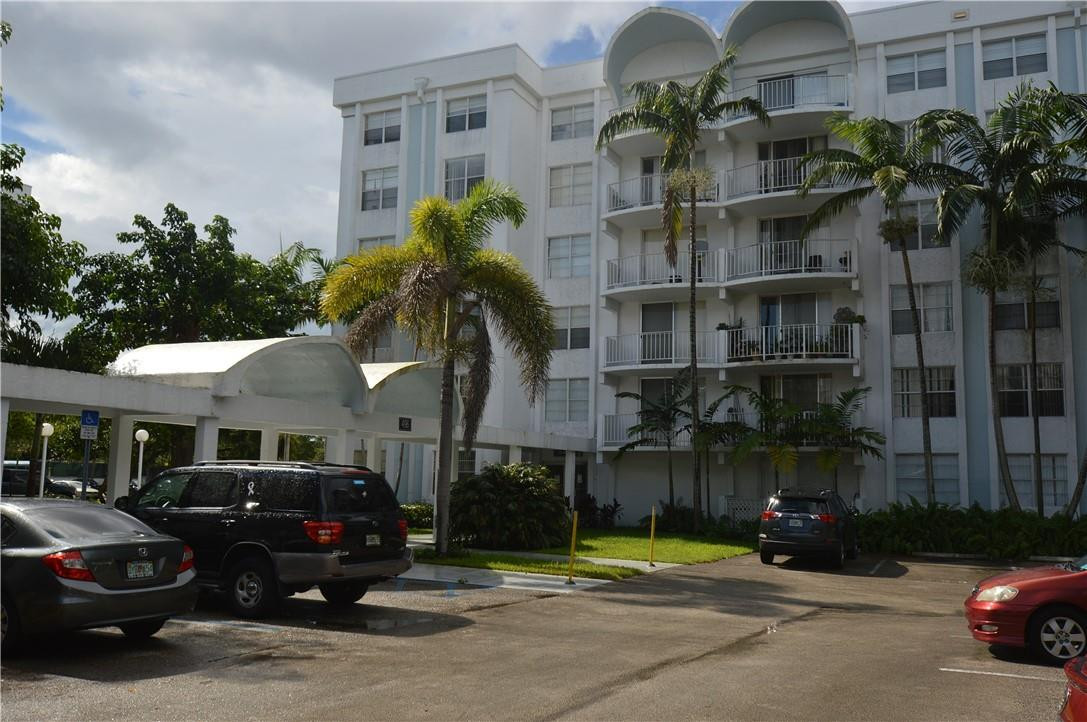 496 Northwest 165th Street, Unit D511 Miami, FL 33169 - Photo 15 of 16 a car parked in front of a building