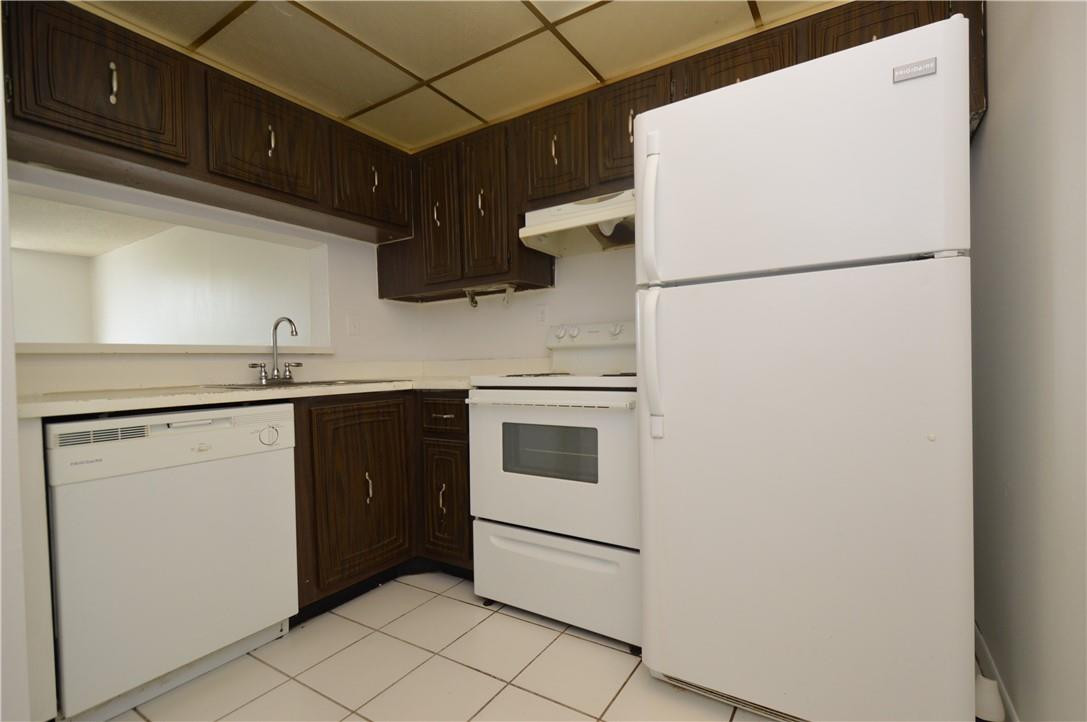 496 Northwest 165th Street, Unit D511 Miami, FL 33169 - Photo 3 of 16 a kitchen with a refrigerator and a sink