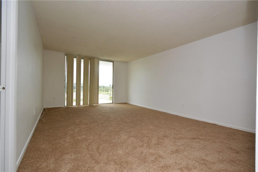 496 Northwest 165th Street, Unit D511 Miami, FL 33169 - Photo 4 of 16 an empty room with windows