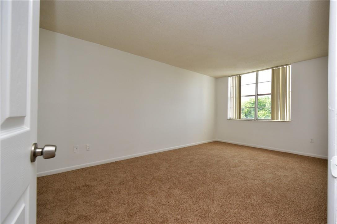 496 Northwest 165th Street, Unit D511 Miami, FL 33169 - Photo 7 of 16 an empty room with windows