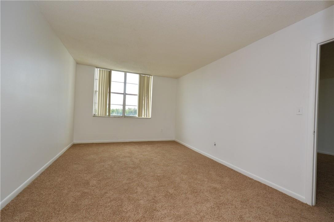 496 Northwest 165th Street, Unit D511 Miami, FL 33169 - Photo 9 of 16 an empty room with windows