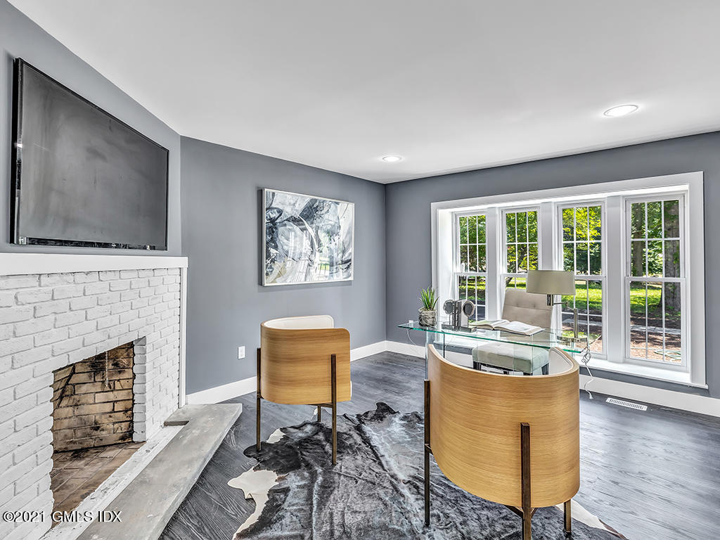 23 Meeting House Road Greenwich, CT 06831 - Photo 26 of 46 a living room with furniture a flat screen tv and a fireplace