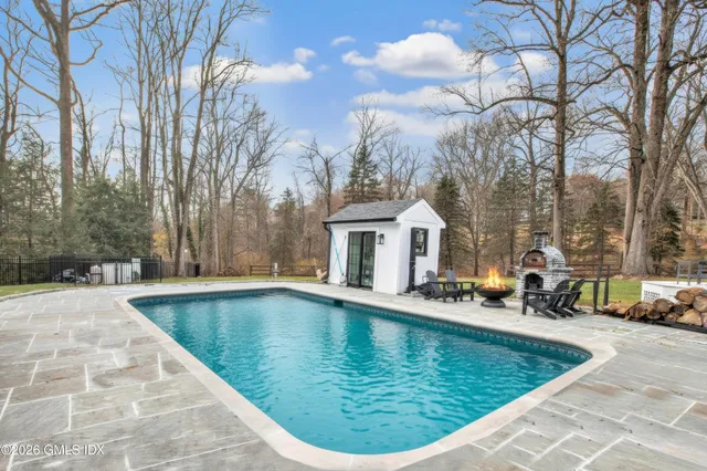 a living room with furniture fireplace and a large window