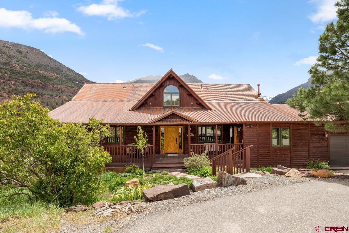 2490 County Road 17 Ridgway, CO 81432 - Photo 6 of 26 a front view of a house with a garden and mountain view