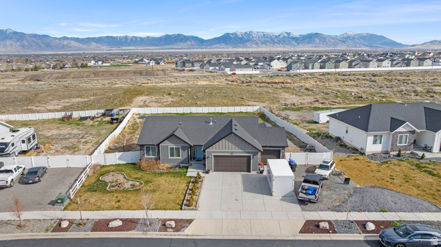 463 South Trejo Ridge Road Grantsville, UT 84029 - Photo 20 of 22 Contemporary single-story residence featuring a two-car garage, partial board and batten siding, and a paved driveway