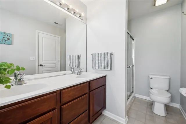 a bathroom with a granite countertop sink a toilet and a mirror