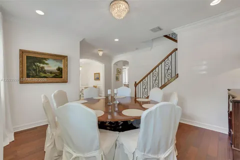 a dining room with furniture and wooden floor