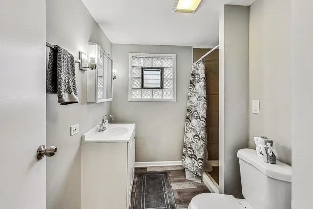 a bathroom with a sink toilet and shower