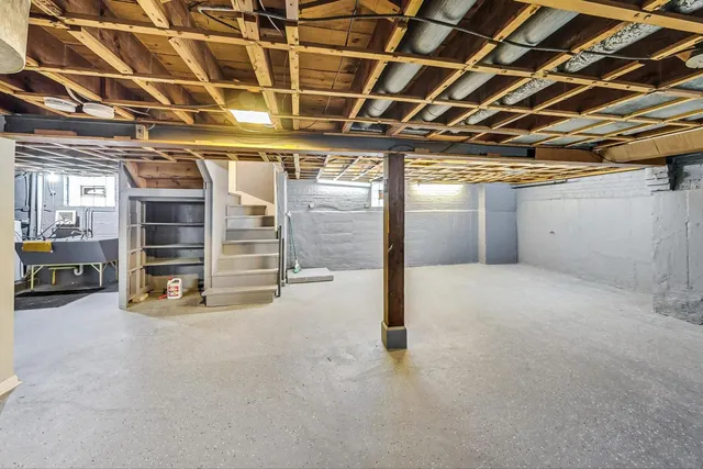 a view of an empty room with a staircase