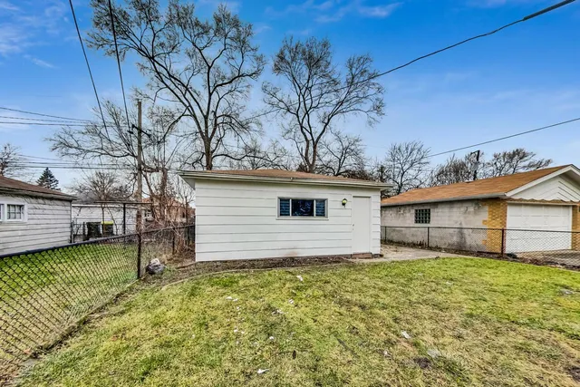 a view of a house with a patio and a yard