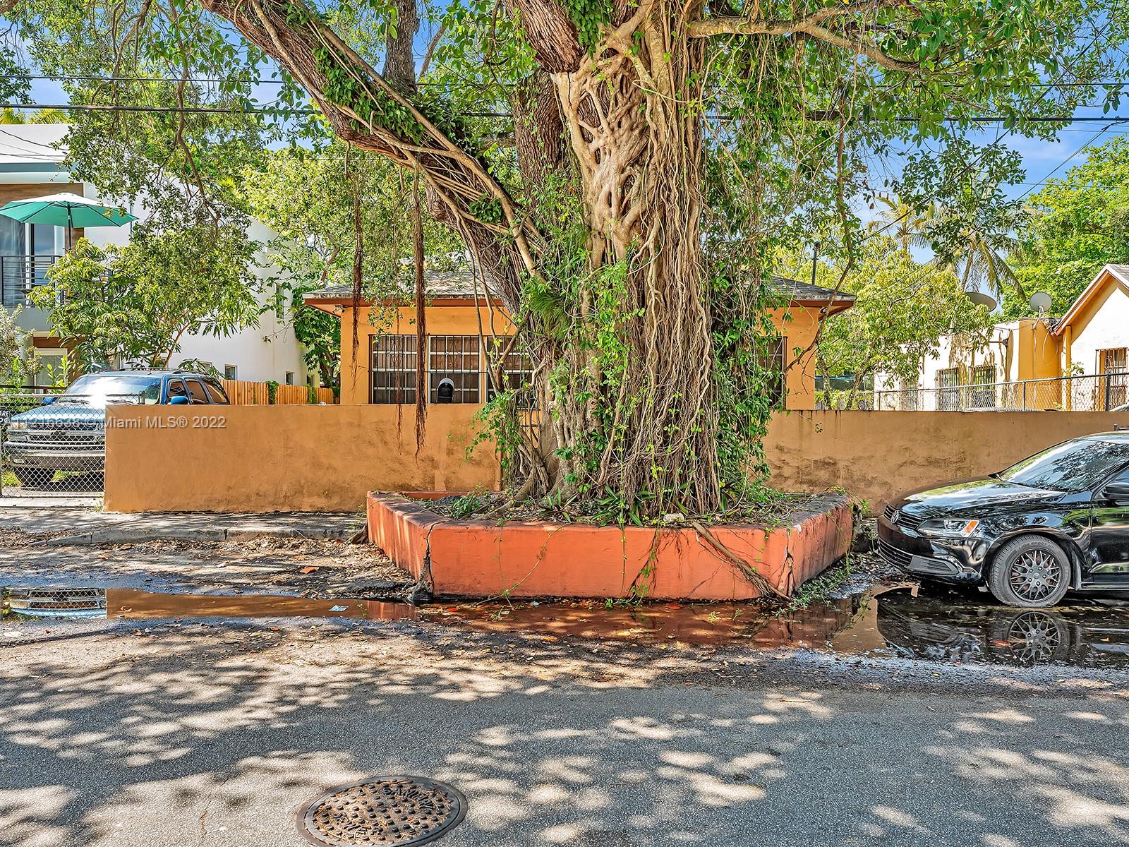 3628 Thomas Avenue Miami, FL 33133 - Photo 4 of 7 an outdoor space with furniture and cars
