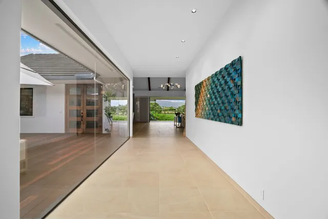 a view of a hallway with wooden floors and plants