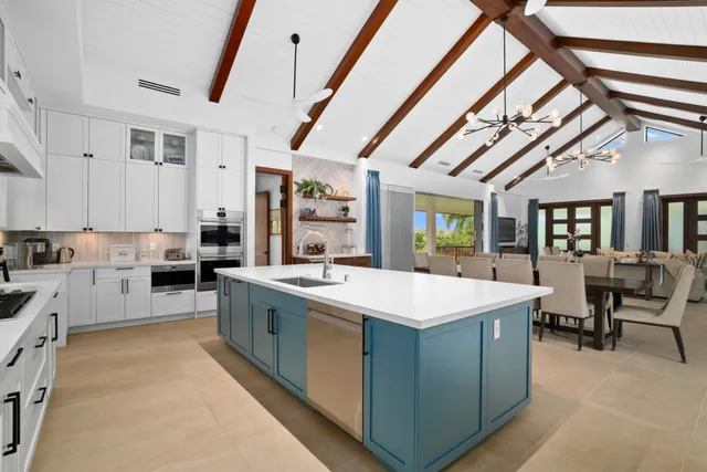 a large kitchen with a stove and a large window