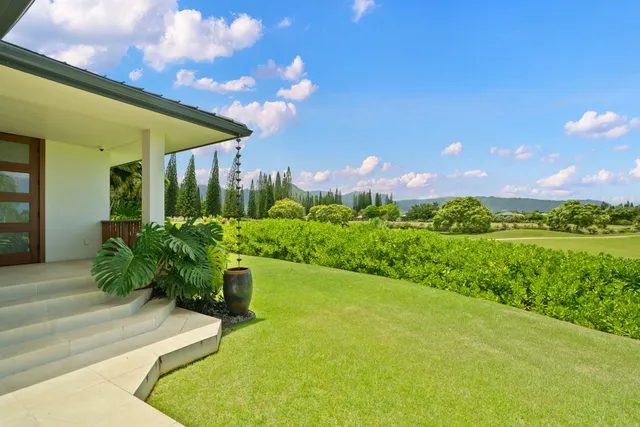 a view of a fountain in front of house with a yard