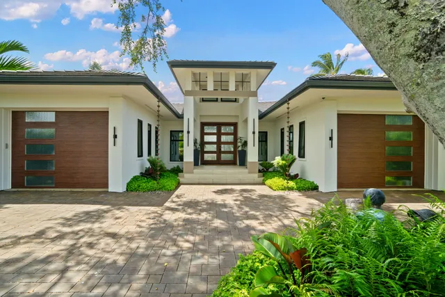 a view of a house with brick walls and a small yard