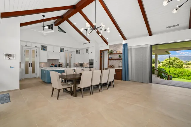 a dining room with furniture and a floor to ceiling window