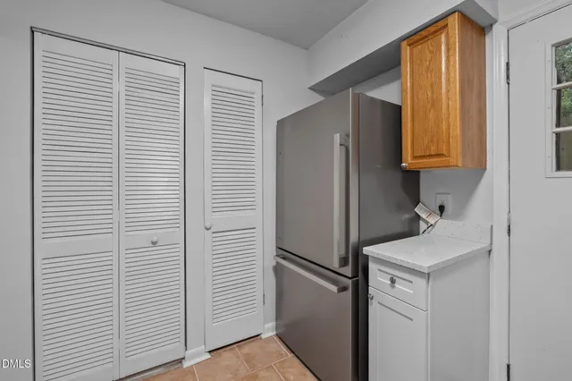 a room with a refrigerator and a window