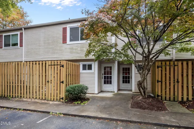 a front view of a house with a tree
