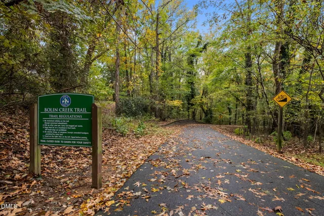 a green field with trees in the background