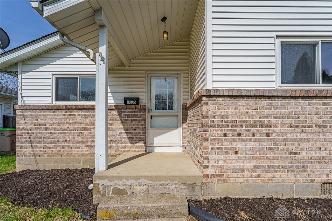 1005 Burt Street Springfield, OH 45505 - Photo 4 of 33 This inviting home showcases durable brick and siding, featuring a charming porch for welcoming arrivals.