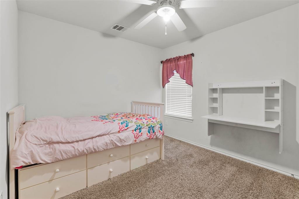 409 Wilson Way Denton, TX 76207 - Photo 20 of 33 White walled room featuring a built-in wall-mounted desk with shelving, a single window with blinds, and a ceiling fan