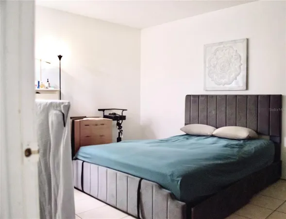 a bedroom with bed and a window