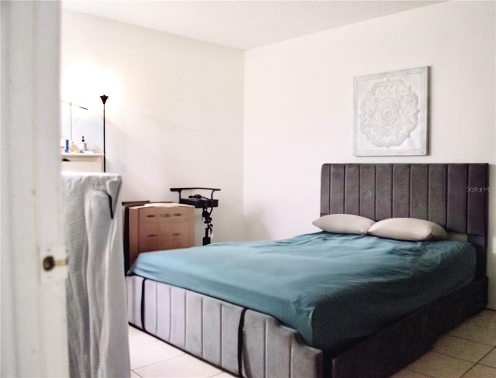 360 Cocoa Court Kissimmee, FL 34758 - Photo 10 of 11 a bedroom with bed and a window