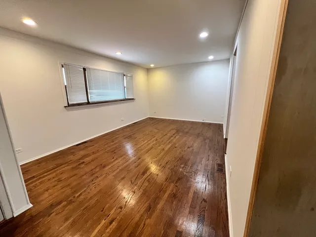 a view of hallway with wooden floor