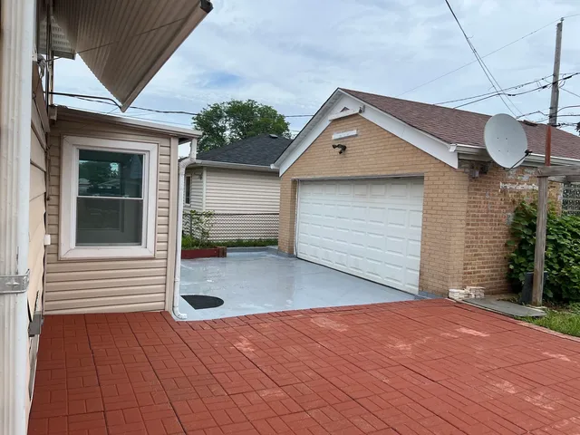 a view of a house with wooden deck and a tub