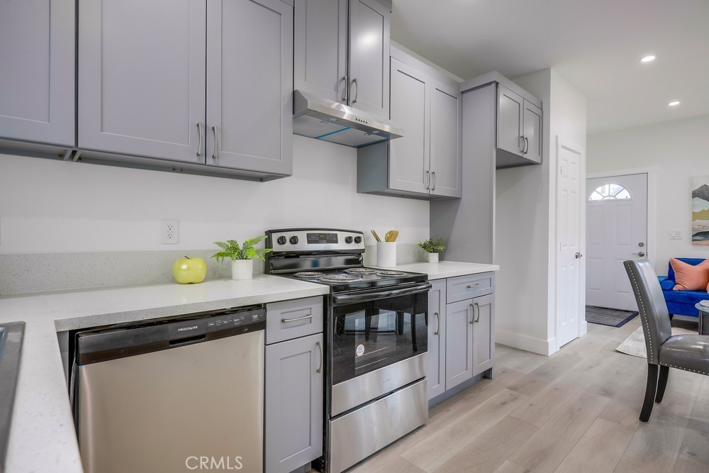6439 Mohawk Road Westminster, CA 92683 - Photo 19 of 41 a kitchen with stainless steel appliances granite countertop a stove a white cabinets a sink and dishwasher