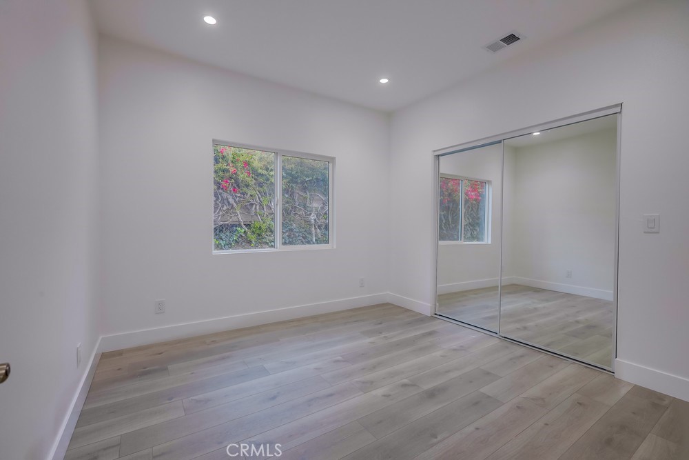 6439 Mohawk Road Westminster, CA 92683 - Photo 31 of 41 an empty room with wooden floor and windows