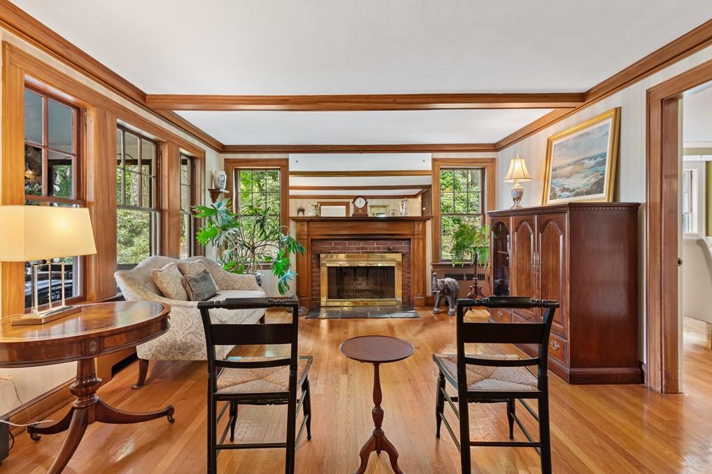 19 Walnut Street Lexington, MA 02421 - Photo 7 of 22 a dining room with furniture a fireplace and wooden floor
