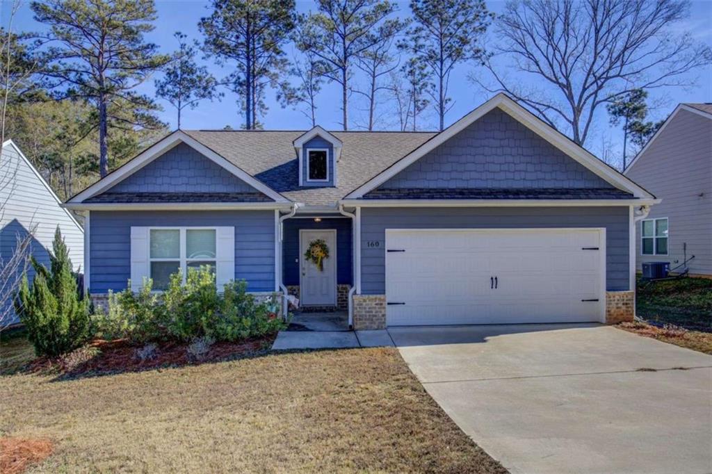 160 Savannah Way Milner, GA 30257 - Photo 1 of 41 a front view of a house with garden