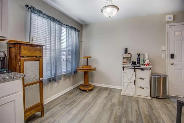 a view of kitchen with furniture wooden floor and window