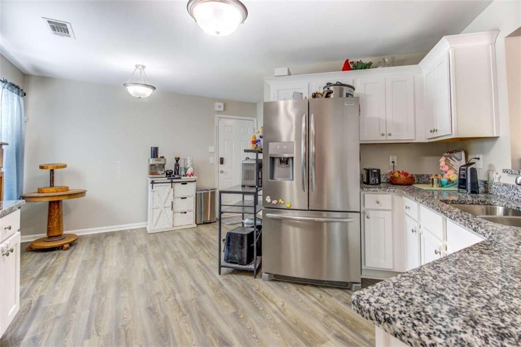 160 Savannah Way Milner, GA 30257 - Photo 13 of 41 a kitchen with kitchen island white cabinets and stainless steel appliances