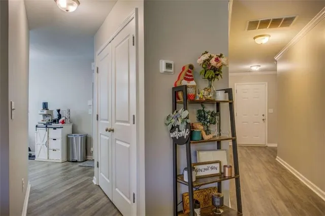 a view of a hallway and wooden floor and a dining room