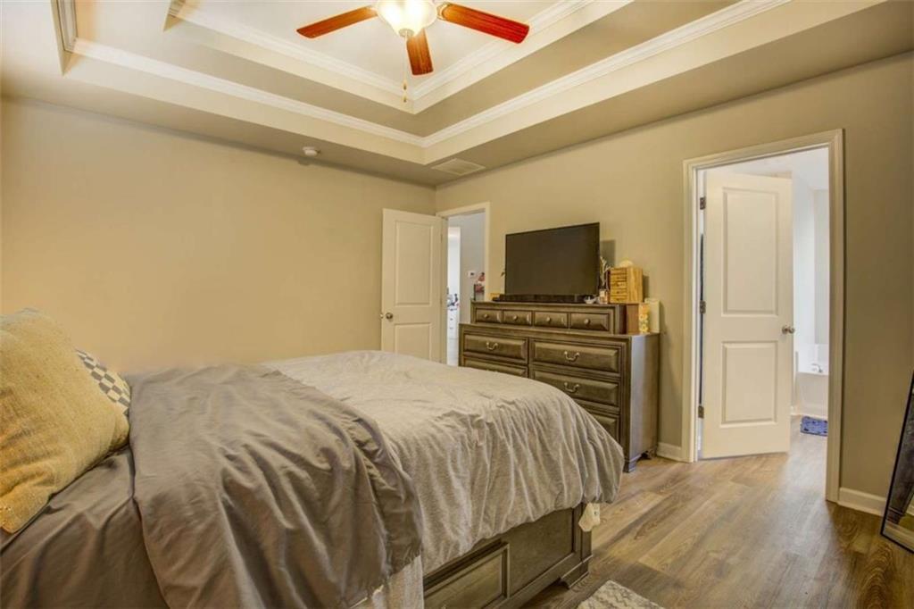 160 Savannah Way Milner, GA 30257 - Photo 19 of 41 a bedroom with a bed and a flat screen tv