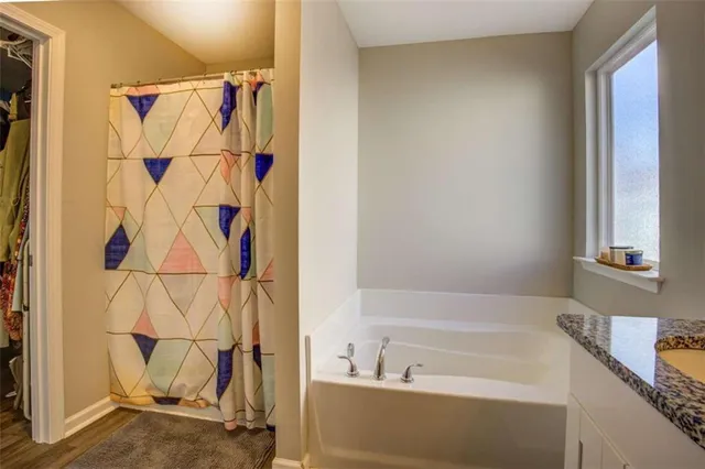 a bathroom with a bathtub and a shower