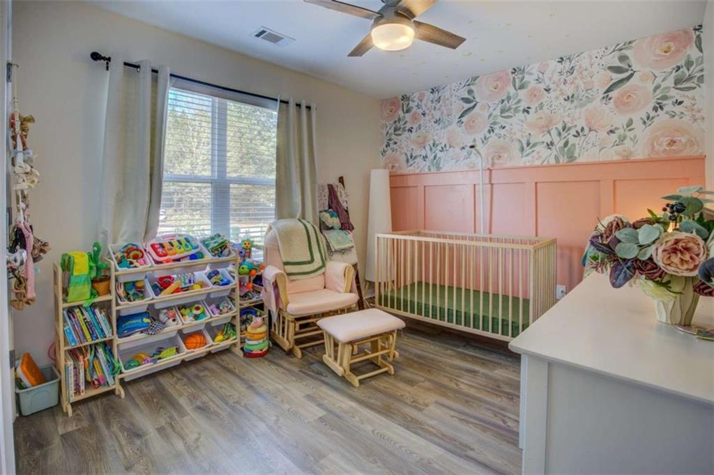 160 Savannah Way Milner, GA 30257 - Photo 23 of 41 a bedroom with furniture and a wooden floor