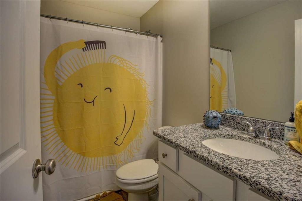 160 Savannah Way Milner, GA 30257 - Photo 25 of 41 a bathroom with a granite countertop toilet sink and mirror